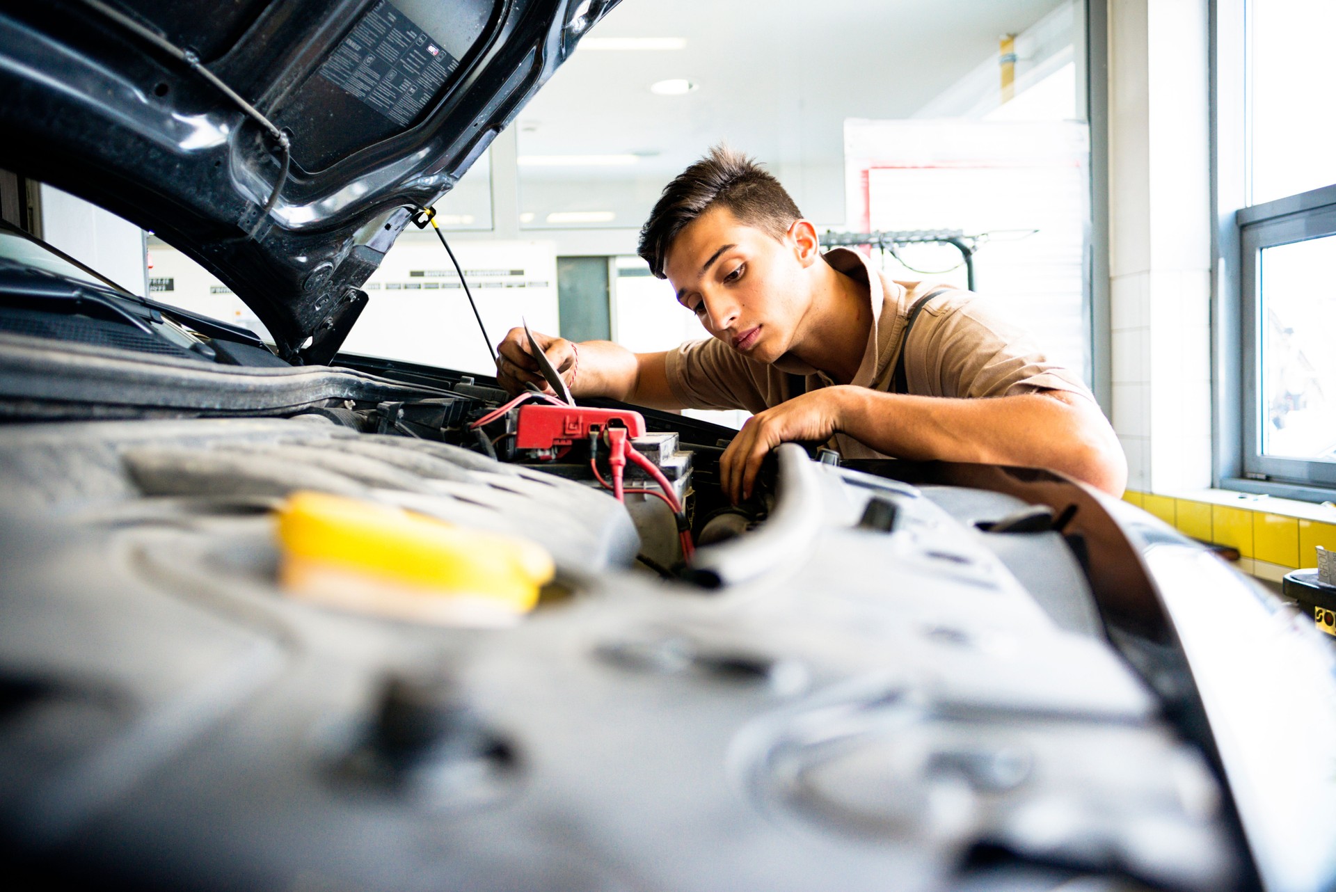 Mechanic in auto repair shop working on car